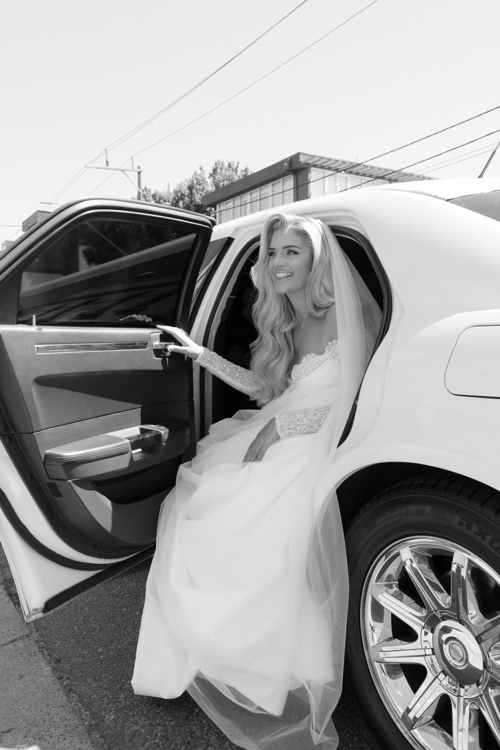 Bride emerging her wedding car.