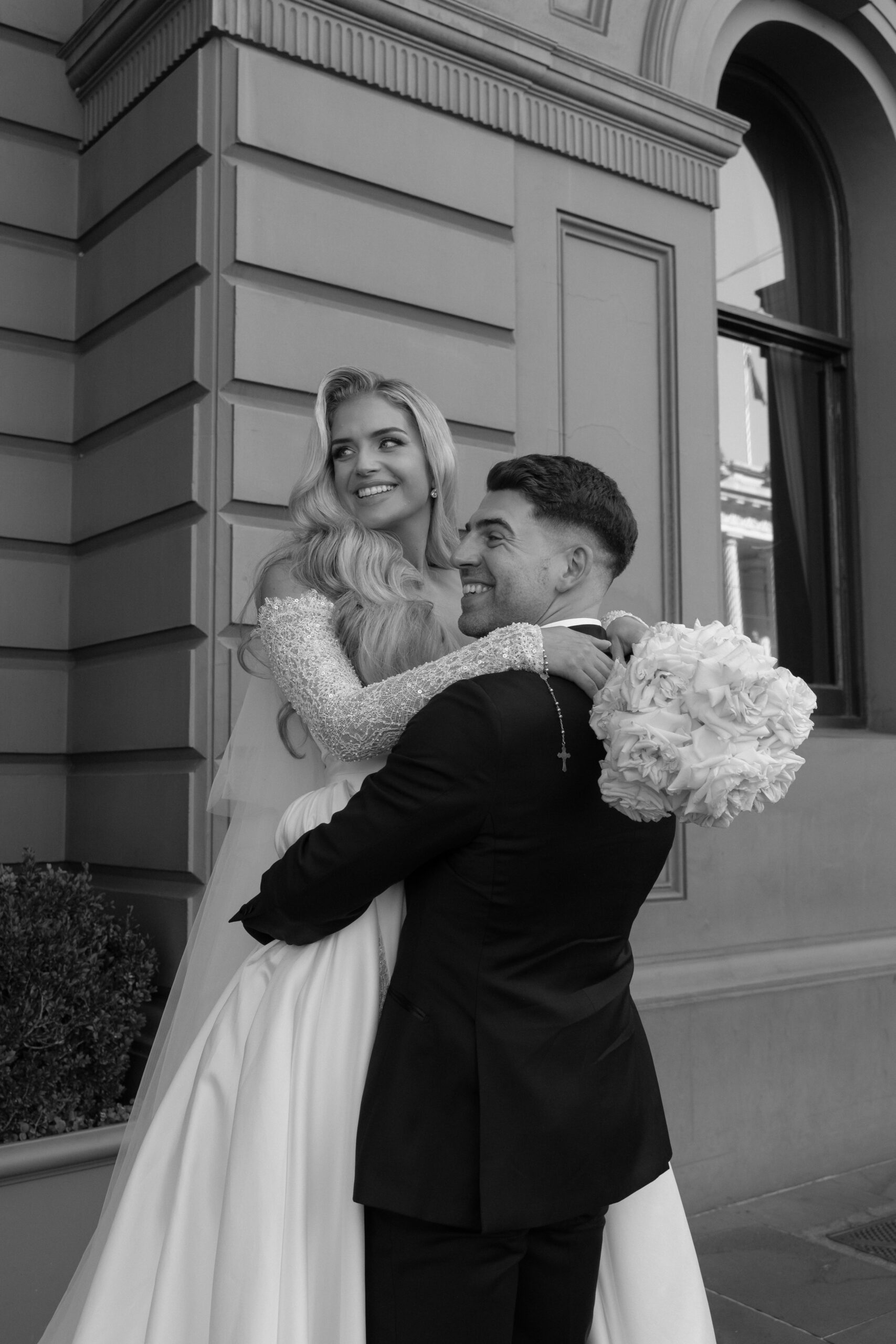 Bride and groom posing for wedding photo.