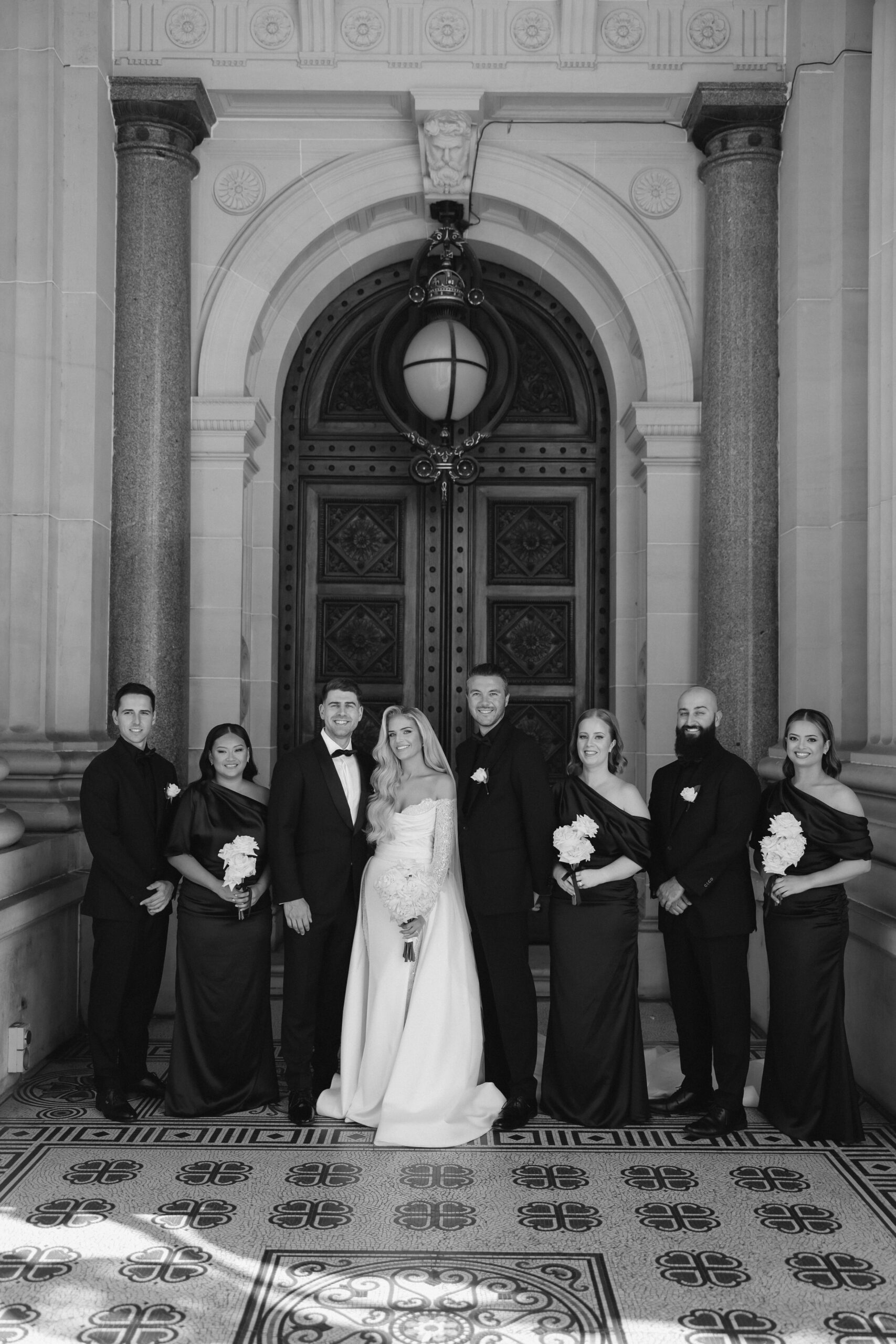 Bridal party posing for photo at parliament building