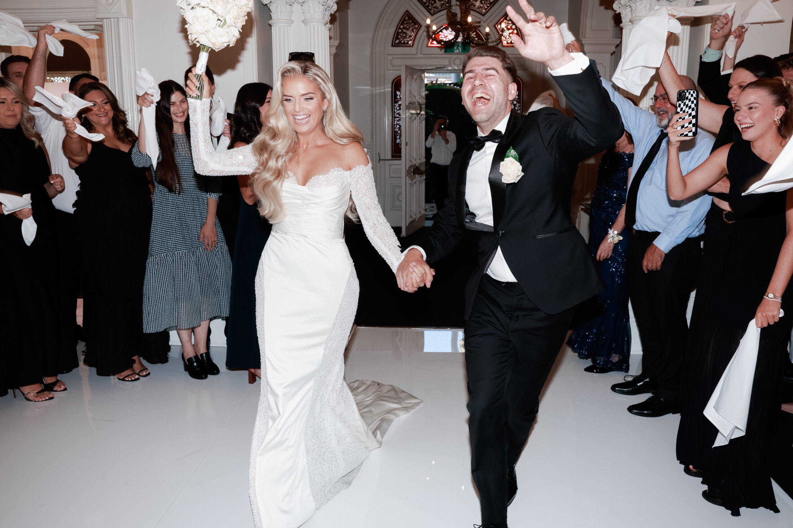 bride and groom walking on to the dancefloor. 