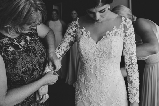 black and white photo bride getting ready wearing off the shoulder lace wedding dress Tibet by Pronovias