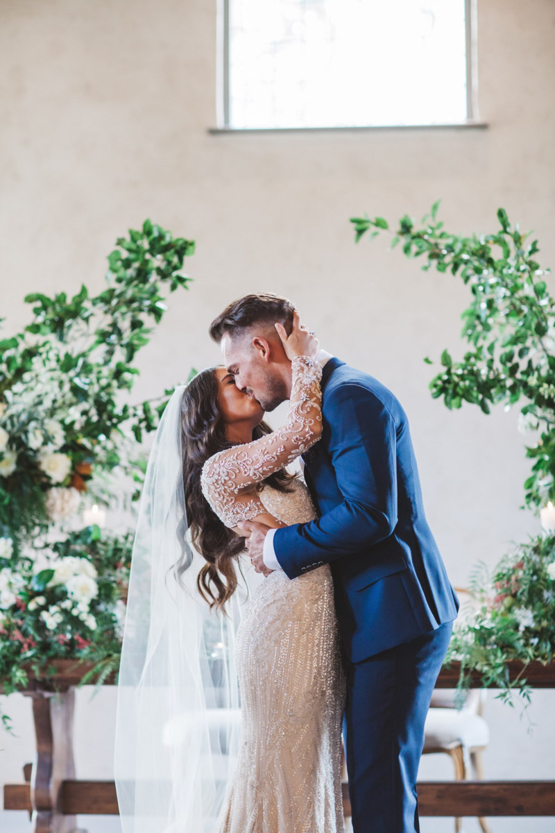 bride and groom kissing - Real bride wears Demetrios Platinum 330 wedding dress