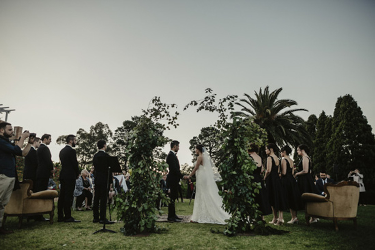 leafy wedding arbour bride and groom ceremony
