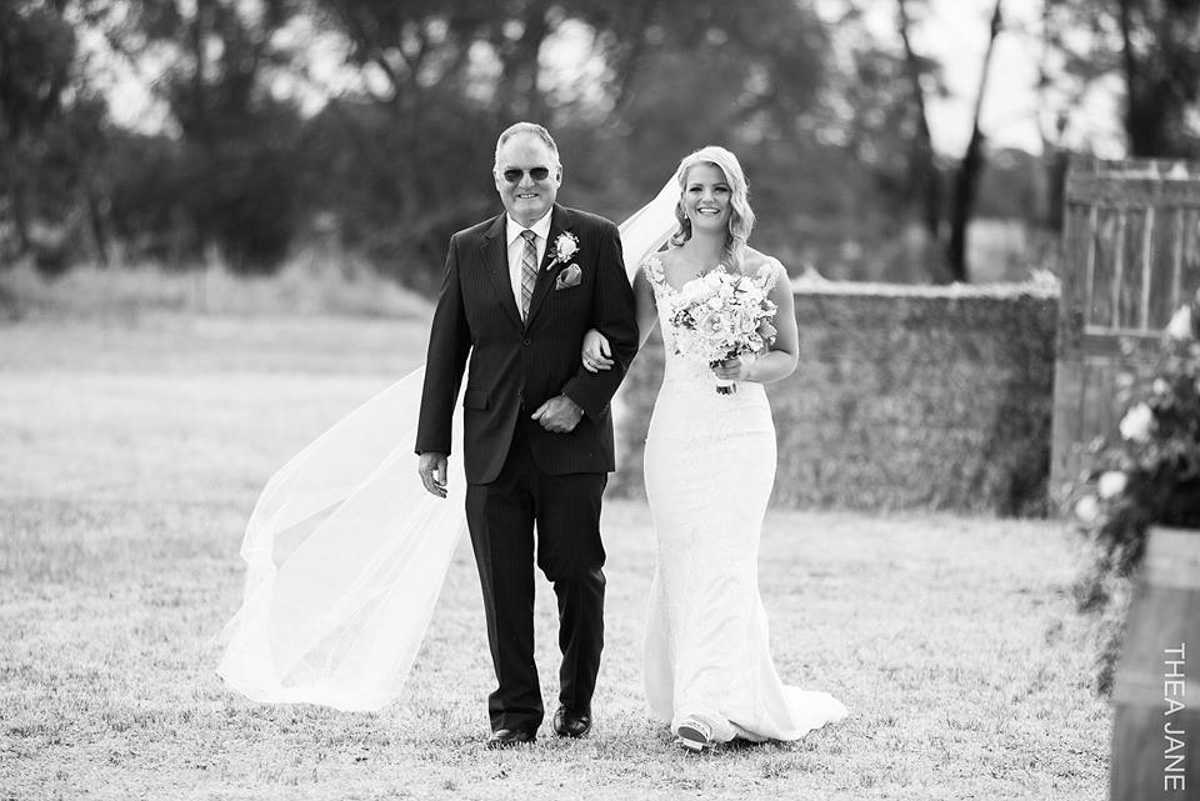 real bride walking with father wearing  tamar wedding dress by pronovias