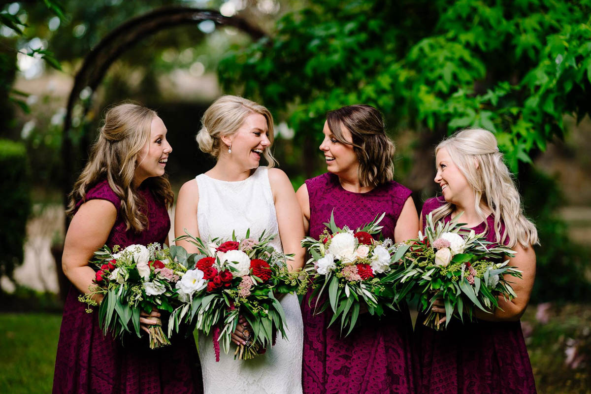 Raffaele Ciuca real bride wearing Ornani wedding dress by Pronovias with bridesmaids wearing burgandy dresses