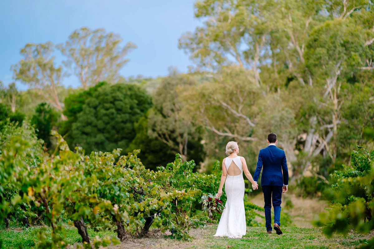 Raffaele Ciuca real bride wearing Ornani wedding dress by Pronovias, photo of bride and groom back